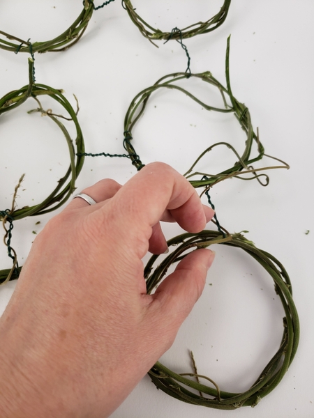 Once all the wreaths are connected gently manipulate the wire so that the panel is flat on the surface.