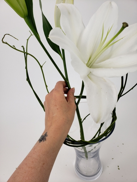 Place the flower stem in the vase Place the flower stem in the vase