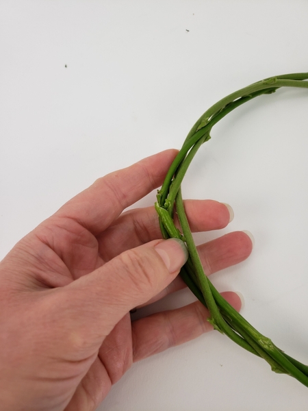 This way the end is concealed and the wreath will stay intact as you wiggle stems through it This way the end is concealed and the wreath will stay intact as you wiggle stems through it