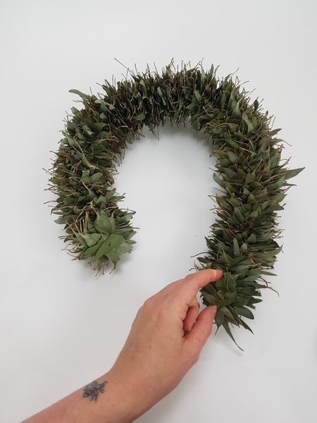 Thread a huge bundle of eucalyptus leaves into string