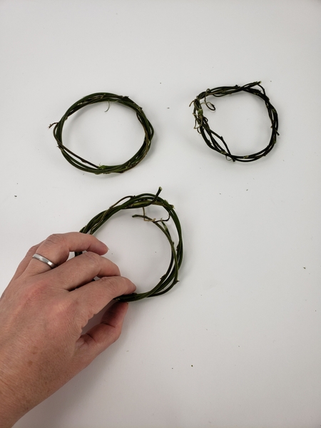 Weave a third wreath exactly the same size as the two before Weave a third wreath exactly the same size as the two before