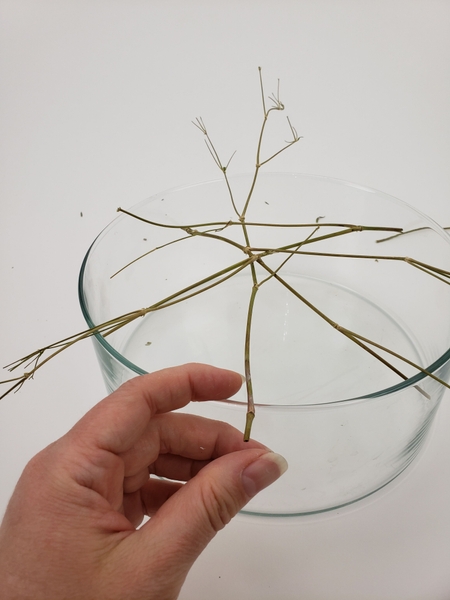 Weave another stem into the container Weave another stem into the container
