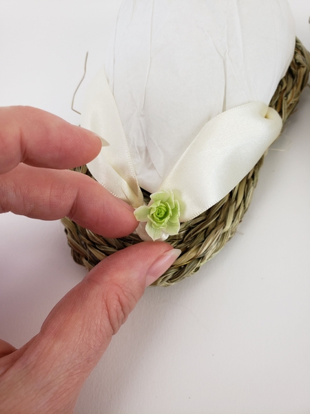 Cut away the stem and glue the flower to the ribbon with floral glue Cut away the stem and glue the flower to the ribbon with floral glue
