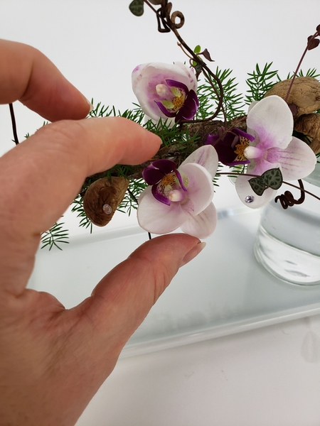 Glue in water tubes to keep the orchids hydrated Glue in water tubes to keep the orchids hydrated