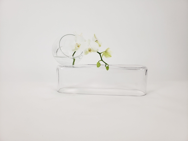 A clear glass and water summer flower arrangement