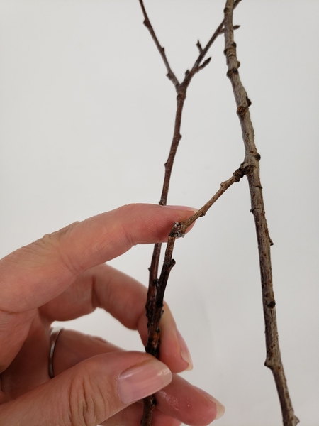 Attach the two twigs with a tiny drop of floral glue Attach the two twigs with a tiny drop of floral glue