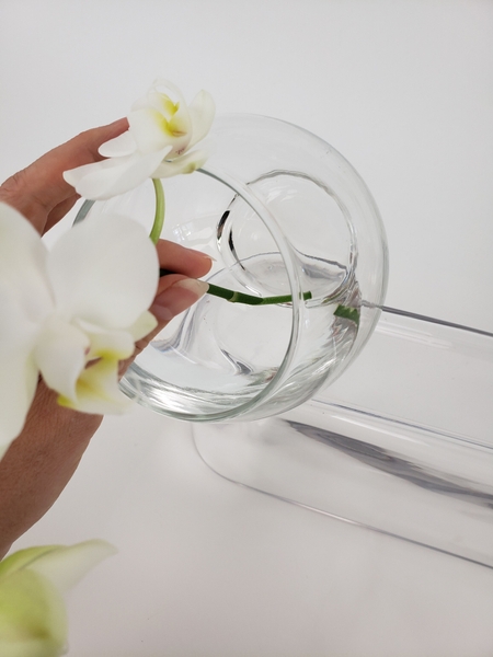 Hook the stem over the top lip of the vase Hook the stem over the top lip of the vase