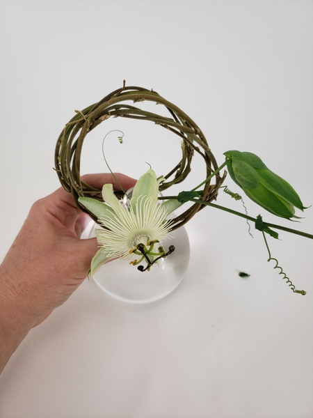 Place the other wreath on the opposite side of the vase Place the other wreath on the opposite side of the vase