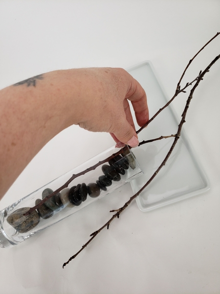 Slip the twig into the vase Slip the twig into the vase