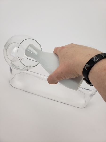 Start pouring water into the vase. Start pouring water into the vase.