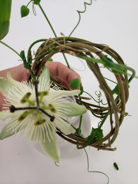 Wind the vine around the opening of the vase Wind the vine around the opening of the vase