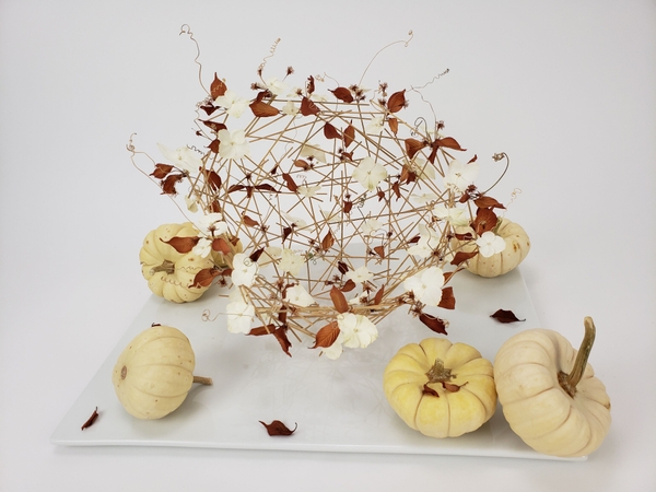 A reed hemisphere armature for a fall floral design A reed hemisphere armature for a fall floral design