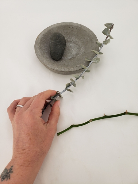 Cut a strong twig to hang the vase from Cut a strong twig to hang the vase from