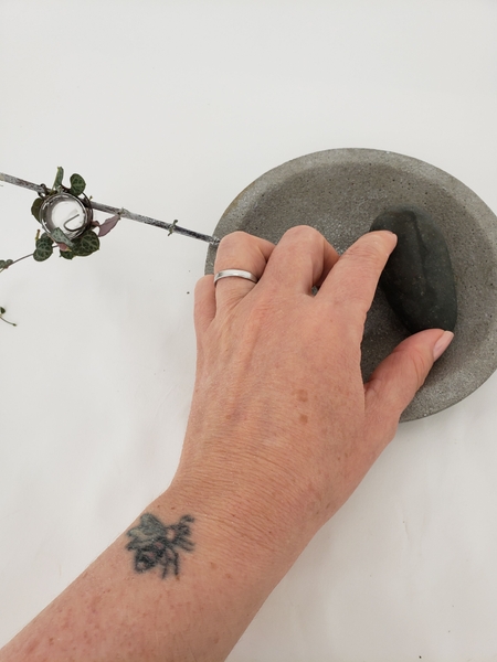 Place a heavy pebble on the opposite twig end Place a heavy pebble on the opposite twig end