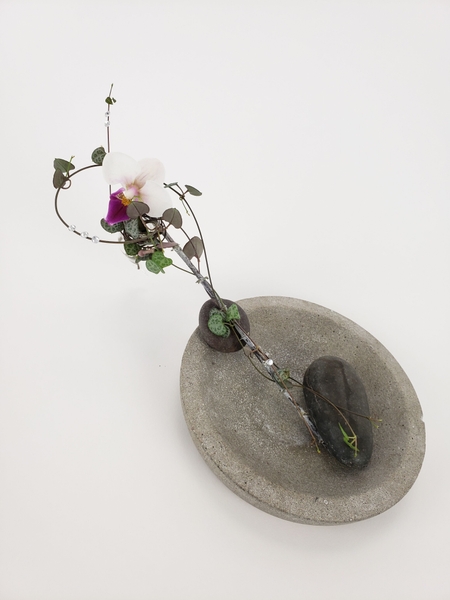 Suspending a small vase from a twig Suspending a small vase from a twig
