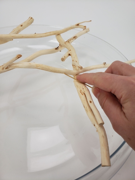 Measure a reed to extend from one twig to another Measure a reed to extend from one twig to another