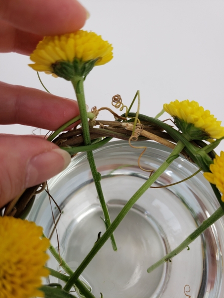 Turn the vase and add more flowers all around Turn the vase and add more flowers all around
