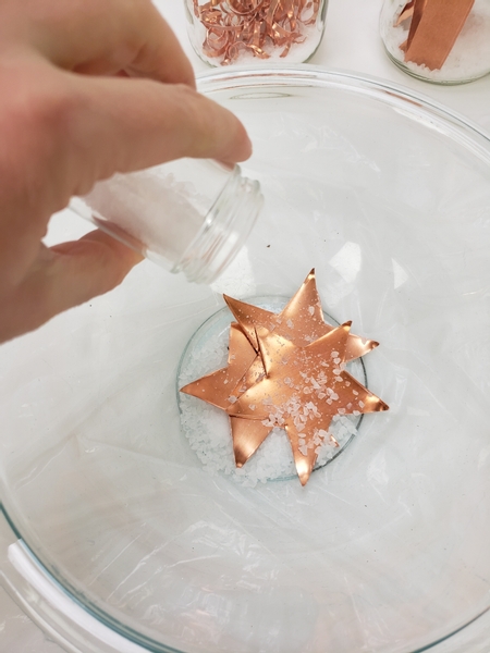 Place the copper in a glass container
